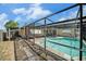 Backyard pool area with a screened enclosure and a well-maintained patio at 2632 Tung Dr, Holiday, FL 34691
