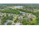 Aerial view of a home in a tree-filled neighborhood close to a lake at 2712 Spring Meadow Dr, Plant City, FL 33566