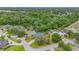 Aerial view of a home in a tree-filled neighborhood close to a lake at 2712 Spring Meadow Dr, Plant City, FL 33566