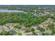 An aerial view of a home in a lush green neighborhood with a nearby lake at 2712 Spring Meadow Dr, Plant City, FL 33566