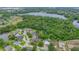 Aerial view of a home in a tree-filled neighborhood close to a lake at 2712 Spring Meadow Dr, Plant City, FL 33566