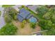 Aerial view of a home showcasing a large screened pool, backyard, and mature landscaping at 2712 Spring Meadow Dr, Plant City, FL 33566