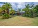 Lush backyard features a screened-in pool, tropical landscaping, and plenty of green space at 2712 Spring Meadow Dr, Plant City, FL 33566