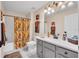 Bright bathroom features a shower-tub combo and a gray vanity with white countertop at 2712 Spring Meadow Dr, Plant City, FL 33566