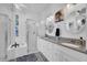 This spacious bathroom offers dual sinks, a granite countertop, and a walk-in shower at 2712 Spring Meadow Dr, Plant City, FL 33566