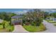Aerial view of charming two-story home with mature trees, beautiful landscaping, and a long driveway at 2712 Spring Meadow Dr, Plant City, FL 33566