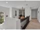 This hallway showcases natural lighting, neutral colored walls, and wood railings at 2712 Spring Meadow Dr, Plant City, FL 33566