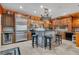 Gourmet kitchen featuring custom wood cabinets, stainless steel appliances, and large center island with seating at 2712 Spring Meadow Dr, Plant City, FL 33566