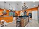 Open-concept kitchen featuring a large island with breakfast bar, custom cabinetry, and backyard access at 2712 Spring Meadow Dr, Plant City, FL 33566