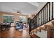 Spacious living room with wood floors, dining table, comfortable couch, and a staircase at 2712 Spring Meadow Dr, Plant City, FL 33566