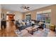Open concept living room with wood floors, a comfortable couch, and views into other living spaces at 2712 Spring Meadow Dr, Plant City, FL 33566