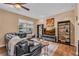 Comfortable living room with a black leather couch, wooden floors, and lots of natural light from a window at 2712 Spring Meadow Dr, Plant City, FL 33566