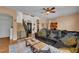 Inviting living room with wood floors, a comfortable couch, and an open staircase leading to the second floor at 2712 Spring Meadow Dr, Plant City, FL 33566