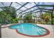 A unique shape pool is enclosed with screens and a nearby patio set at 2712 Spring Meadow Dr, Plant City, FL 33566