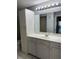 Bathroom features a large vanity with storage and a full-size mirror and lighting at 2753 Countryside Blvd # 107, Clearwater, FL 33761