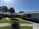 Well-maintained condo community with mature landscaping, sidewalks, and lush green lawns at 2753 Countryside Blvd # 107, Clearwater, FL 33761