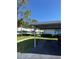 Covered parking area of the home with a well-maintained landscape and building facade in the background at 2753 Countryside Blvd # 107, Clearwater, FL 33761