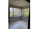 Tiled sunroom has plenty of natural light and a view of the neighborhood at 2753 Countryside Blvd # 107, Clearwater, FL 33761