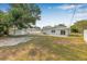 Spacious backyard with shed, patio and mature trees at 2858 State Road 590, Clearwater, FL 33759