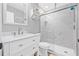 Clean bathroom features a marble-look shower, white vanity, and modern fixtures at 2858 State Road 590, Clearwater, FL 33759
