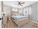 Bright bedroom features a ceiling fan, wood-look floors, and soft, neutral decor at 2858 State Road 590, Clearwater, FL 33759