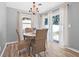 Cozy dining area features a round table, wicker chairs, and lots of natural light at 2858 State Road 590, Clearwater, FL 33759