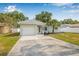 Charming single Gathering home featuring a private drive, attached garage and well-maintained lawn at 2858 State Road 590, Clearwater, FL 33759