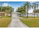 Charming single Gathering home featuring a private drive, attached garage and well-maintained lawn at 2858 State Road 590, Clearwater, FL 33759