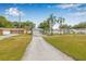 Charming single Gathering home featuring a private drive, attached garage and well-maintained lawn at 2858 State Road 590, Clearwater, FL 33759
