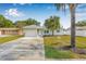 Charming single Gathering home featuring a private drive, attached garage and well-maintained lawn at 2858 State Road 590, Clearwater, FL 33759