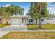 Charming single Gathering home featuring a private drive, attached garage and well-maintained lawn at 2858 State Road 590, Clearwater, FL 33759