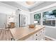 Bright kitchen featuring a center island, stainless steel refrigerator and view of the dining area at 2858 State Road 590, Clearwater, FL 33759