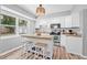 Bright kitchen featuring a center island with seating, stainless steel appliances and ample cabinet space at 2858 State Road 590, Clearwater, FL 33759