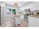 Bright kitchen featuring a center island with seating, stainless steel appliances and ample cabinet space at 2858 State Road 590, Clearwater, FL 33759