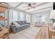 Inviting living room featuring wood beam ceilings, wood floors, and stylish furnishings at 2858 State Road 590, Clearwater, FL 33759