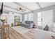 Inviting living room featuring wood beam ceilings, wood floors, and stylish furnishings at 2858 State Road 590, Clearwater, FL 33759