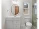 Bright bathroom with a white vanity, toilet, shower, and ample mirror at 2936 W Knights Ave # A, Tampa, FL 33611