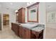 Elegant bathroom features double vanities with granite countertops, wood cabinets, and tile floors at 2936 W Knights Ave # A, Tampa, FL 33611