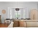 Bright dining area featuring modern light fixture, large windows, and neutral tones at 2936 W Knights Ave # A, Tampa, FL 33611