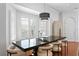 Bright dining area featuring modern light fixture, large windows, and neutral tones at 2936 W Knights Ave # A, Tampa, FL 33611