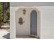 Charming arched doorway with a decorative water feature and hanging lantern at 2936 W Knights Ave # A, Tampa, FL 33611