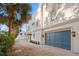 A view of the side of the house showcases the garage and lush landscaping at 2936 W Knights Ave # A, Tampa, FL 33611