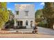 Charming two-story home with a white exterior, blue awnings, and meticulous landscaping at 2936 W Knights Ave # A, Tampa, FL 33611