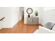 Hallway featuring hardwood floors, neutral walls, and a cabinet at 2936 W Knights Ave # A, Tampa, FL 33611