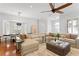 Open-concept living area with hardwood floors, large windows, and stylish furnishings at 2936 W Knights Ave # A, Tampa, FL 33611