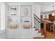Bright living area showcasing custom built-ins, a staircase, and access to kitchen at 2936 W Knights Ave # A, Tampa, FL 33611