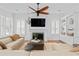 Cozy living room with a white fireplace, built-in shelving, and hardwood floors at 2936 W Knights Ave # A, Tampa, FL 33611
