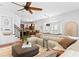 Open-concept living room with hardwood floors, staircase, and a view of the kitchen at 2936 W Knights Ave # A, Tampa, FL 33611