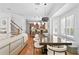 Bright living area open to kitchen and dining area with wood floors and neutral tones at 2936 W Knights Ave # A, Tampa, FL 33611