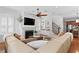 Bright living room with hardwood floors, fireplace, large sectional sofa, and built-in shelving at 2936 W Knights Ave # A, Tampa, FL 33611